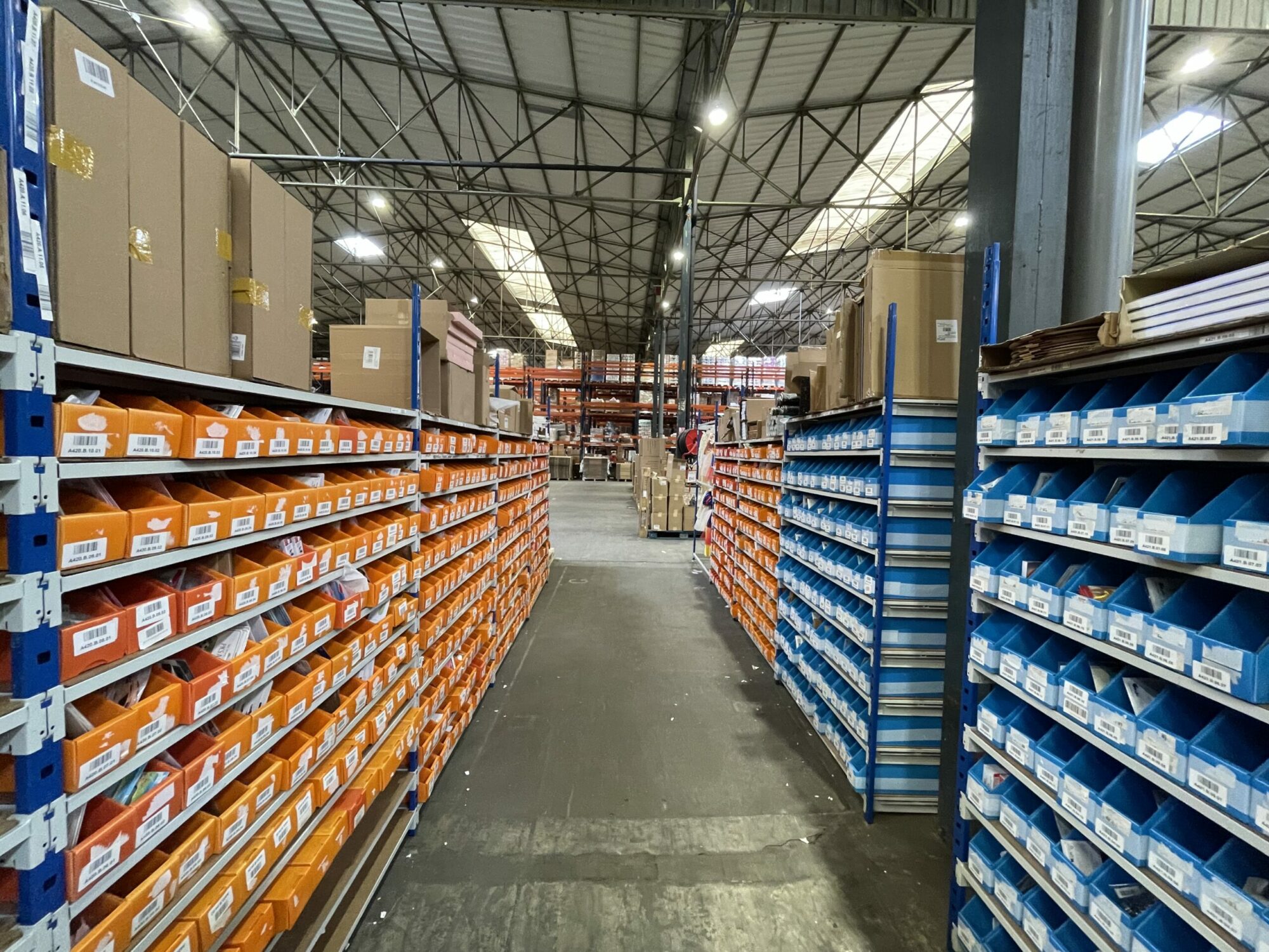 Bins and cartons, placed on shelves